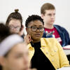A student wearing a yellow jacket.