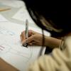 Art therapy student drawing on paper.
