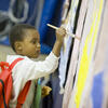 A young child painting.