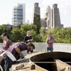 Students studying architecture with the Philadelphia city skyline behind them.