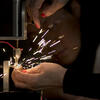 A tyler student working with metal.