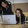 A Tyler architecture student smiling at a computer.