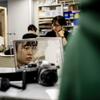 A student using a camera in front of a mirror.