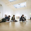 Students sketching and taking notes in a museum.