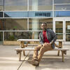 David Herman sitting at a table outside in Tyler's courtyard. 