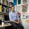 Philip Glahn leaning on a desk and looking at the camera.