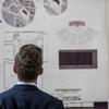 A student looking at a poster.