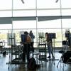 Students painting inside a Tyler classroom with floor-to-ceiling windows and easels.