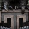 An owls feet resting on a Temple T.