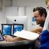 A professor and student talking in class.