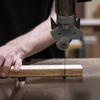 Student using a saw to cut wood.