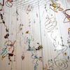 An abstract artwork created by an art history student made of wire shapes hanging from string 