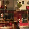 A Phildadelpia street view reflected in the window of a restaurant.