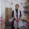 Sonja Bijelic standing in a studio space, looking at the camera, surrounded by work.
