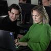 Two graduate students using computers.