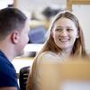 A Tyler student smiling and having a conversation.