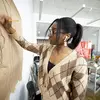 Student drawing on brown paper on a wall