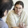 A Tyler printmaking student talking to a professor.