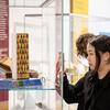 A Tyler student inspecting art history related items.