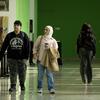 Students walking through a green hallways
