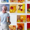 painting student studies artwork on a wall