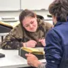 student observes a historical book