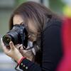 A Tyler photography student using a camera.