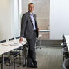 Clifton Fordham, wearing a suit, standing inside Tyler School of Art and Architecture.