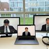 3 screens show a student in a suit with closed eyes facing the camera