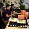 Graduate design students working in a graduate studio space.