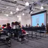 Presenters speaking to a group of students at a panel discussion