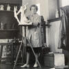 Portrait of Stella Elkins Tyler working on a sculpture in an art studio