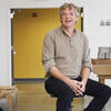 Stephen Anderson sitting on a stool inside Tyler, smiling warmly at the camera.