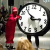 Student dressed all in red and student dressed as a clock at a runway show