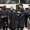 Graduating students pose together in front of Tyler Hall.