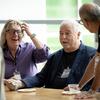 3 faculty members talking and smiling