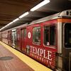 a subway car with temple university branding on the side