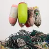 Buoys hanging above a pile of rope.