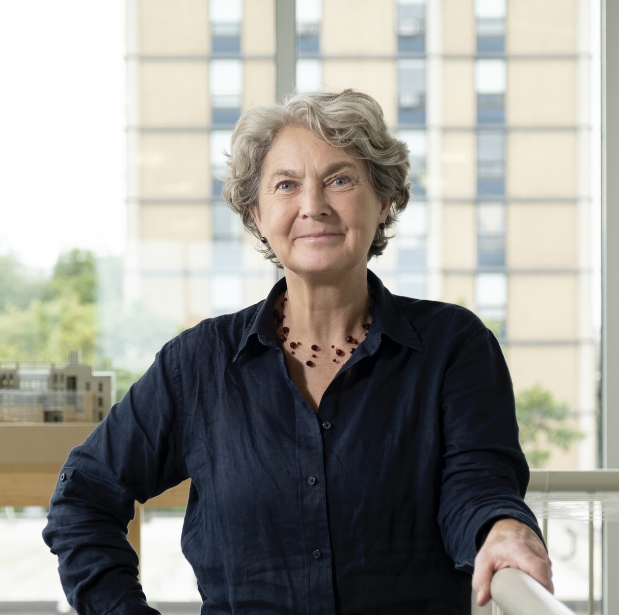 Photo of Kate Wingert-Playdon wearing a blue shirt, looking at the camera