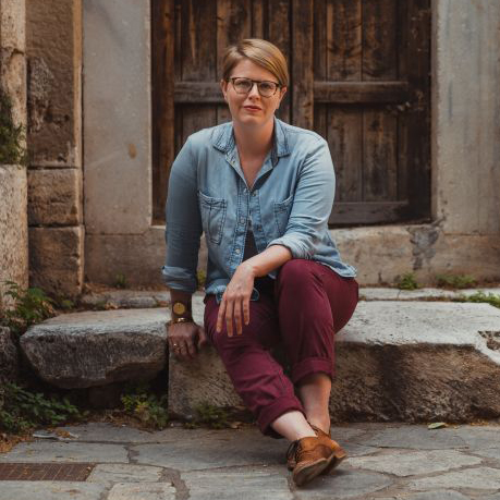 Emily Neumeier sitting outdoors on a step