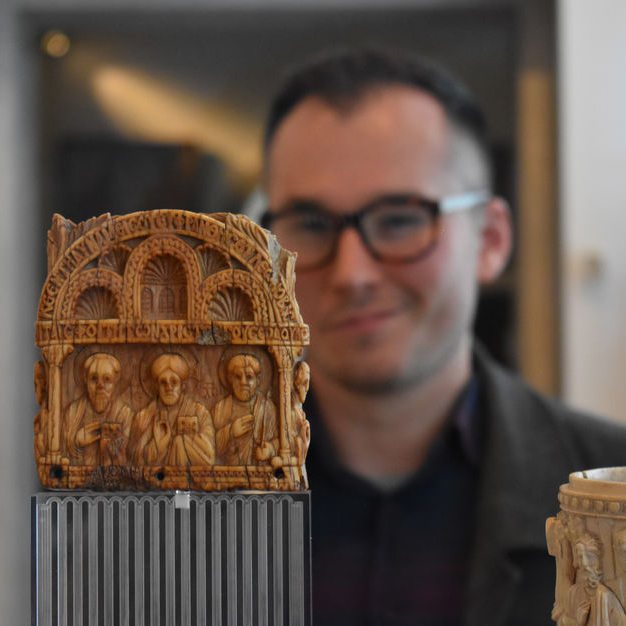 Joseph Kopta behind a medieval art piece