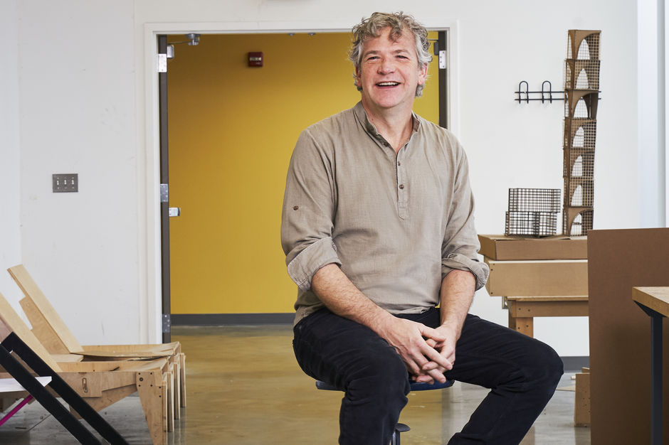 Stephen Anderson sitting on a stool inside Tyler, smiling warmly at the camera.